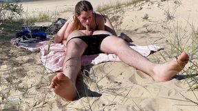 Nudist couple enjoying blowjob at the beach