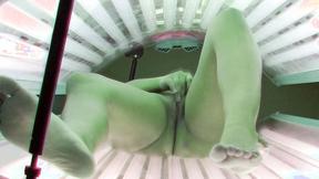 ”Bombshell Brunette Masturbating in Solarium”