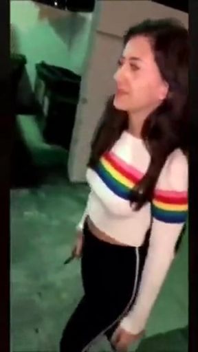 Girl in colorful sweater standing outdoors