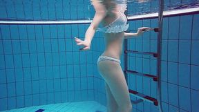 Red haired swimmer Diana Zelenkina is stripping under the water