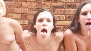 three bimbos sit public with their tongues out having fun with spit