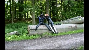 Two girls in latex touch each other