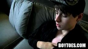 Amateur hunk rubbing on his feet on the couch