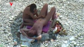 beach voyeur. a girl relaxes on a nudist beach with a dick in her pussy