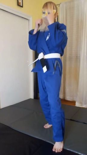 POV roundhouse kick in blue BJJ gi