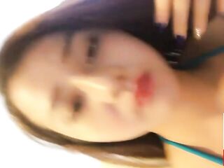 Lovely Vietnamese honey is often posing in front of the camera and showing her cleavage