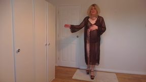 Blonde stripping out of a negligee and lace gown
