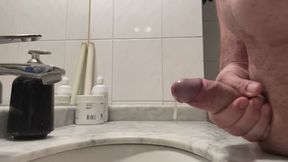 Slow-motion side view of a handjob ending in ejaculation.