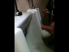 two slim dicks getting wanked at the urinals