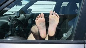 Dylan poses their bare feet up against glass (720)