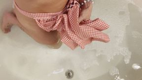 Carissa in the vintage apron and bra in the bath with bare feet