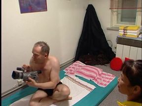 Two thais giving this man a massage