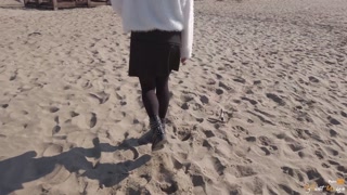 Hot girl masturbates on a bench at a public beach near people strolling