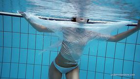 Flat chested chick Marusia exposes her pubic hair while swimming in the pool