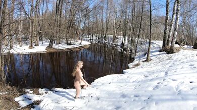 Naked girl in a winter village