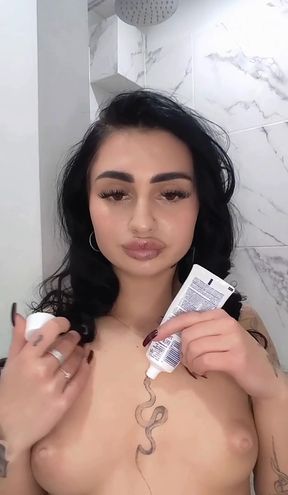 Nude woman holding toothpaste