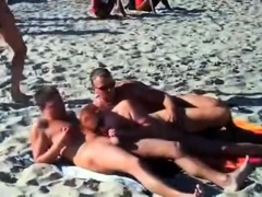 Amateur swingers enjoying hardcore group sex on the beach