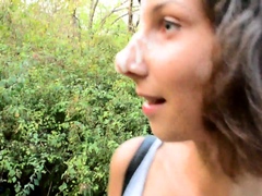 Beautiful young brunette gets facialized in a public park