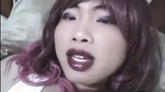 Asian crossdresser strokes small cock on sofa with toy