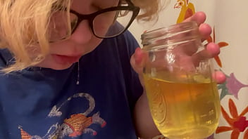 trans boy pisses in a cup and spits it out