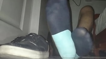 Blue sweaty socks and barefeet