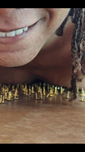 A Little Masochistic Submissive Lying on Thumbtacks