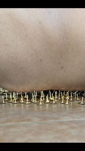 A Little Masochistic Submissive Lying on Thumbtacks