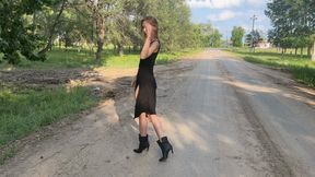 girl in high heeled boots walking in the mud