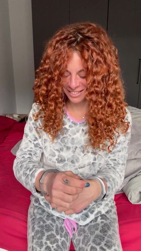 Curvy redhead bound in handcuffs