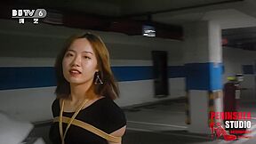 Young Chinese Girl Walks Around Carpark Tied Up