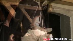 ”Gagged brunette is spanked by master in dungeon play”