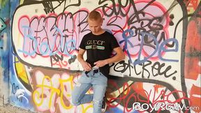 Young guy masturbates in public in front of graffiti wall