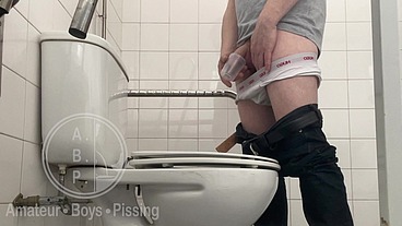 In the Hospital Toilets, a Guy Pisses Into a Cup for a Urine Sample, Then Gets Horny, Jerks-off and Cums
