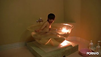 Japanese babe is giving a blowjob to her roommate from a martini glass shaped bath tub