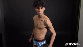 Curly twink boy shows off his slim body on webcam