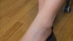 Shoe Dangling with Arched Feet in Black Flats