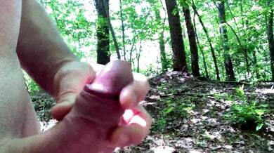 Man hikes naked through the forest while edging with his hand on his cock