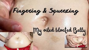 Fingering & squeezing my oiled bloated belly