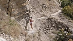 Hiking without clothes but with a toy