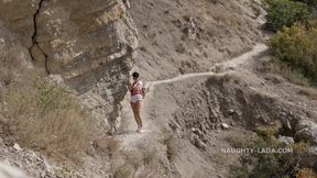 Hiking without clothes but with a toy
