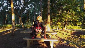 Trans person in pvc outfit enjoys machine sex on picnic table