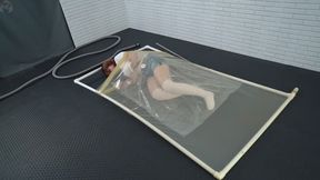 Sonya experiments with a vacuum bag inside a transparent latex vacuum bed