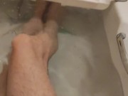 skinny twig strokes his cock and pissed in sink and shows off feet in bathtub