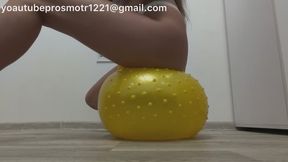 Barefoot and in her underwear, Nastya stomps very hard on a yellow inflatable fitness ball—stepping on it with her full weight, sitting on it, and bouncing—doing it all very hard.