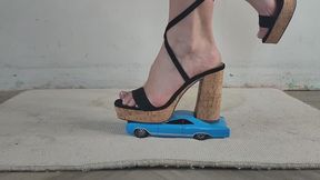 Giantess goddess Charlie Caroline Crushes a 1966 Buick Wildcat in big chunky heels with painted toenails close ground view