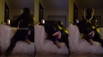 Cowgirl pleasure riding in a glossy latex mask while she fucks herself with a dildo on high heels