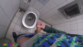 Pissing on a highway toilet, then jerking off my thick foreskin cock until it squirts cum into the bowl.
