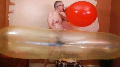 Perverted stepdad plays with huge balloon in front of the camera