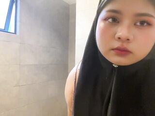 Hijabi sucking her own titties