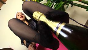 Petra playing with a bottle of champagne with her feet in stockings (480p)